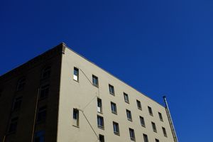 Building with windows set at a jaunty angle against a blue sky.